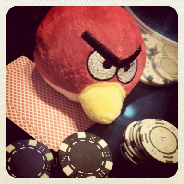 angry bird plush toy next to some poker chips