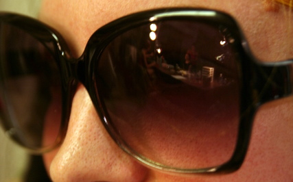 a close up po of a woman wearing sunglasses