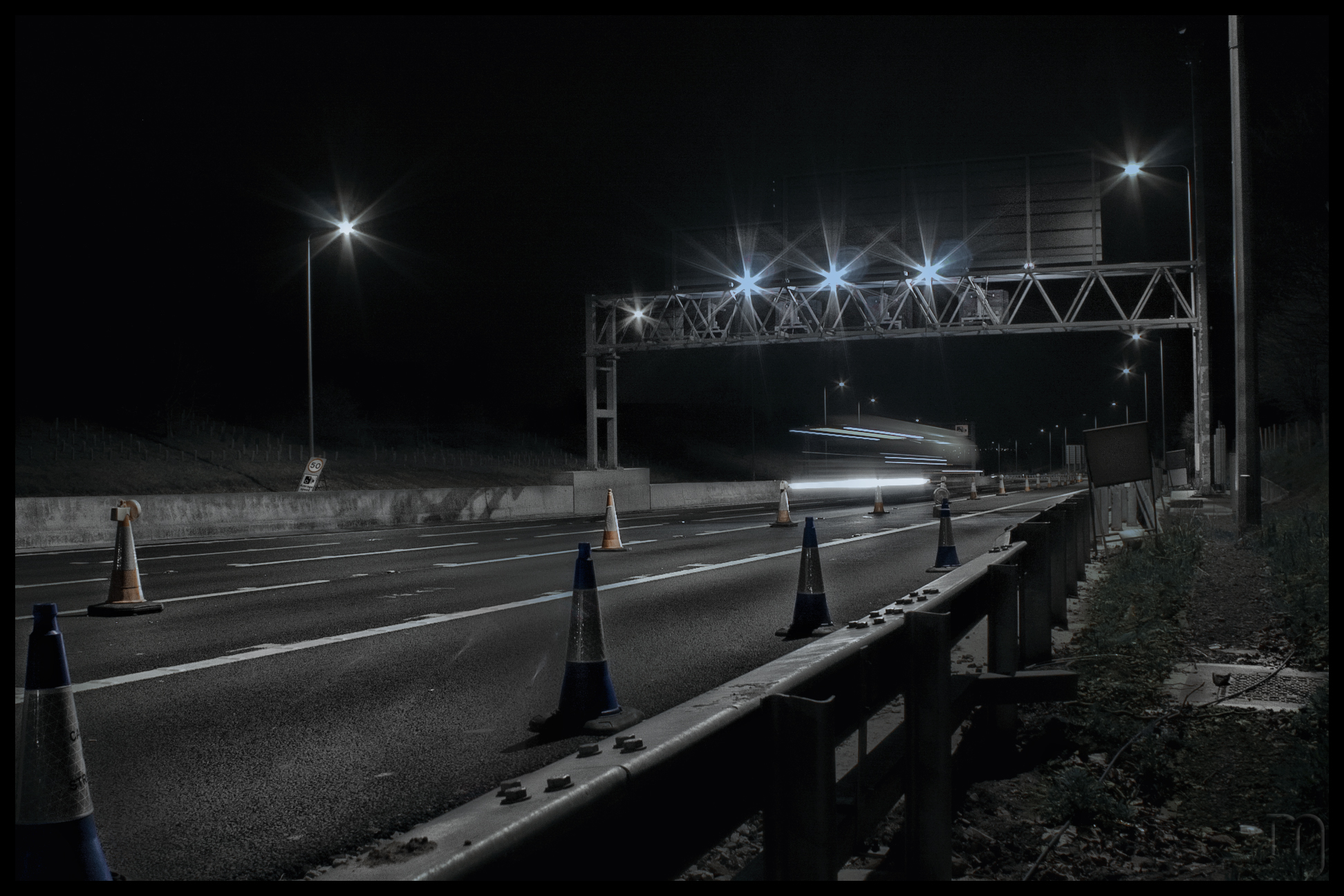 long dark highway at night with lights and markings