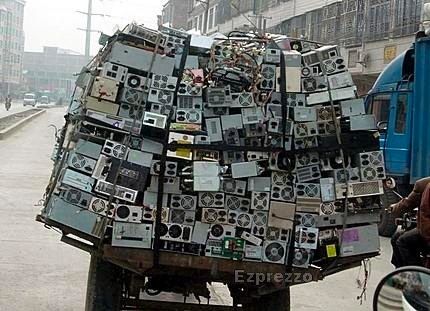 a man riding in the back of a large truck with lots of electronics