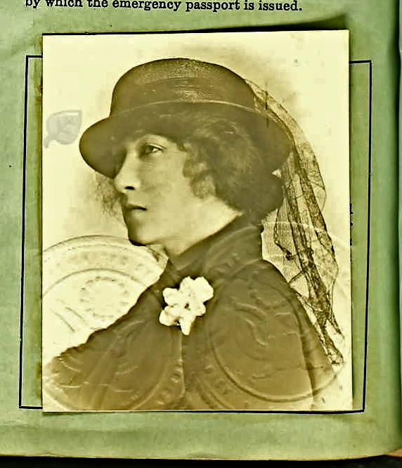 a woman with a hat on posing in an antique po