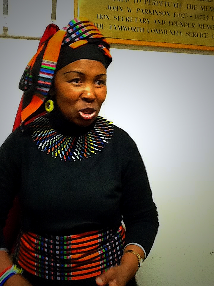 a woman is wearing a multi - colored scarf around her head