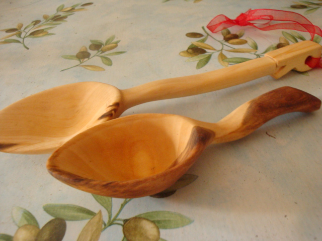 two wooden spoons resting on an embroidered surface