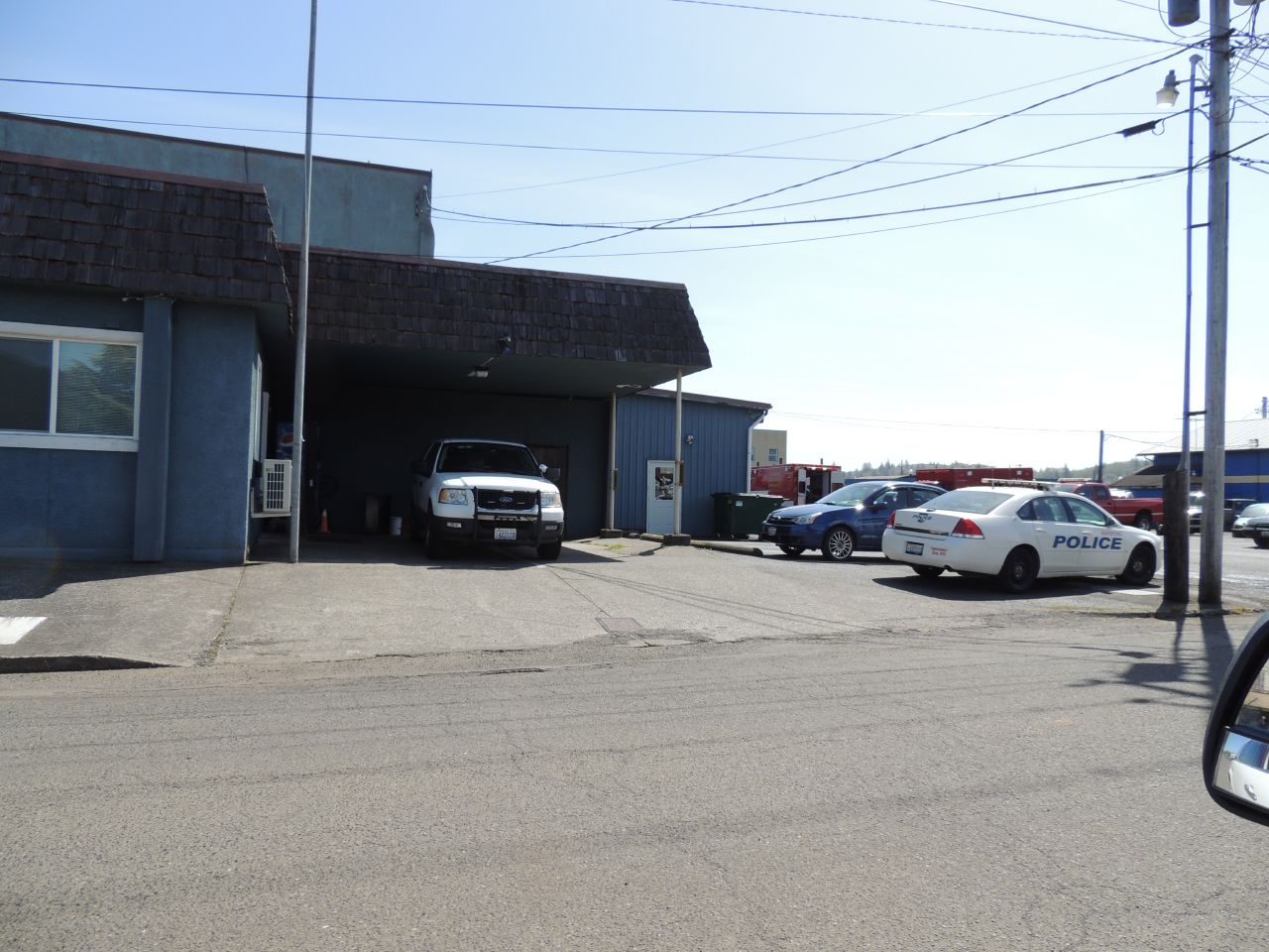 the police car is parked next to the building