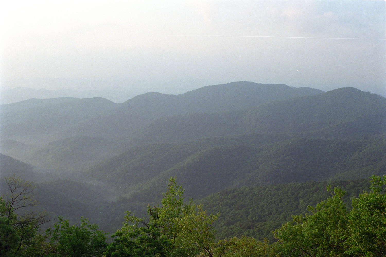 a view of a vast valley covered in mountains