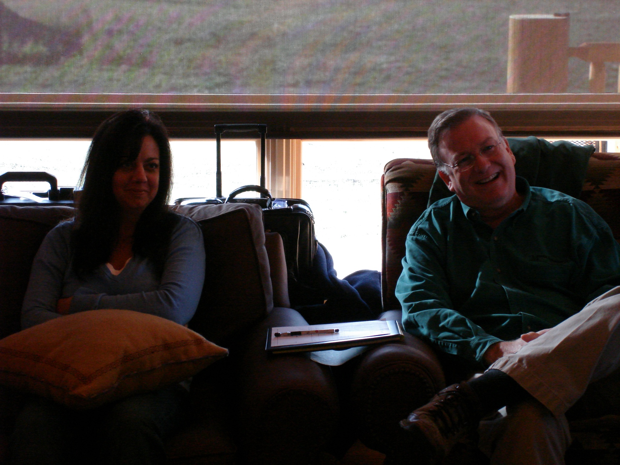 two women and a man are sitting on a couch