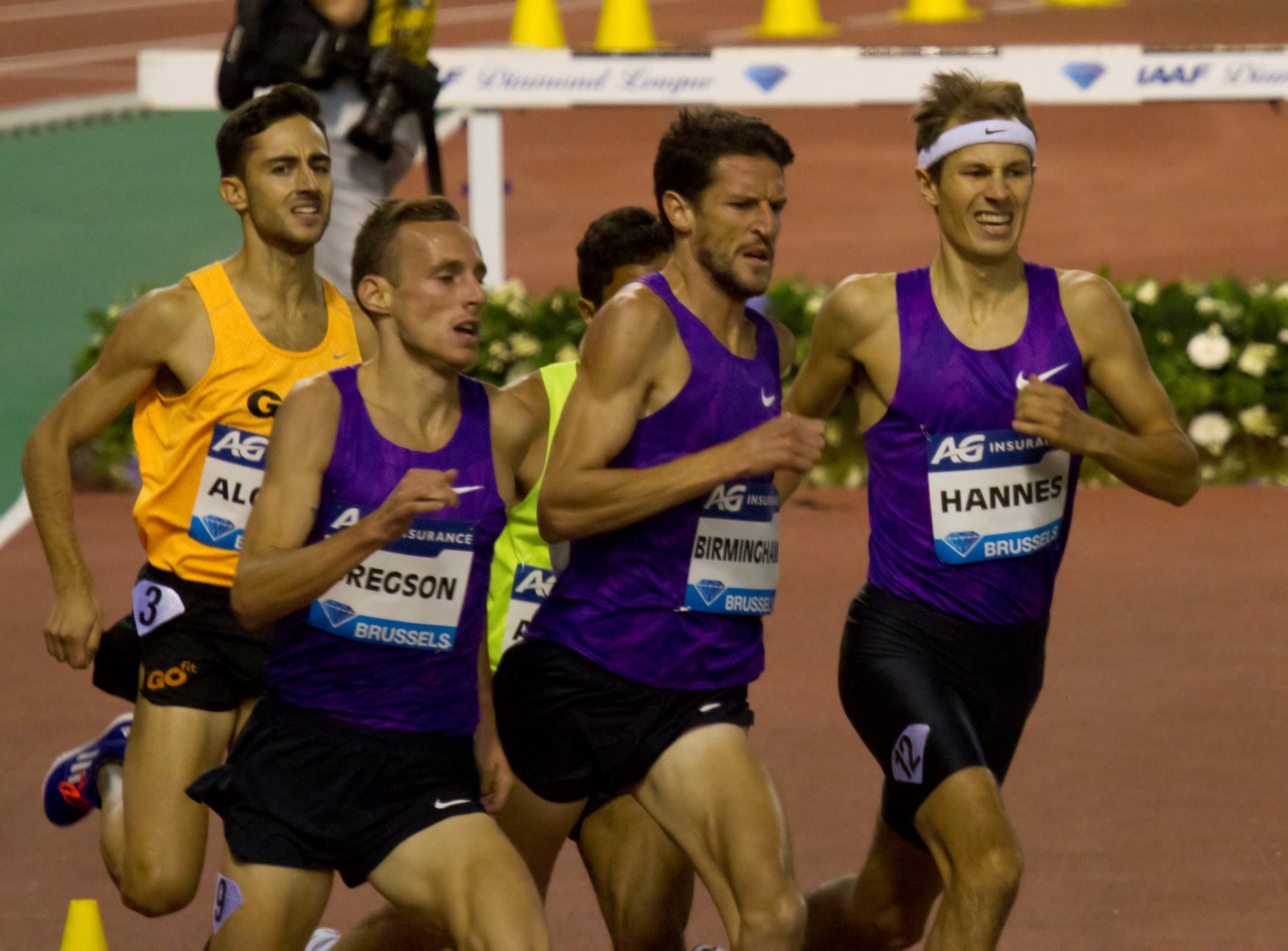 several men racing on a track during the day