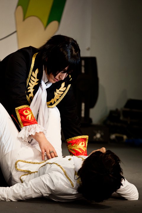 an asian man performing a dance with one hand on the ground