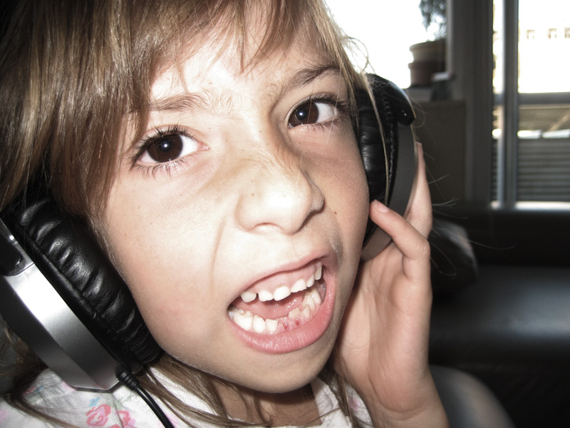 the  has her headphones up and is excited