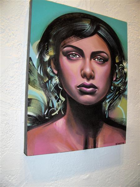 a painting of a woman's face on the wall