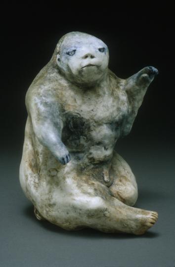 a white and brown ceramic statue with blue eyes