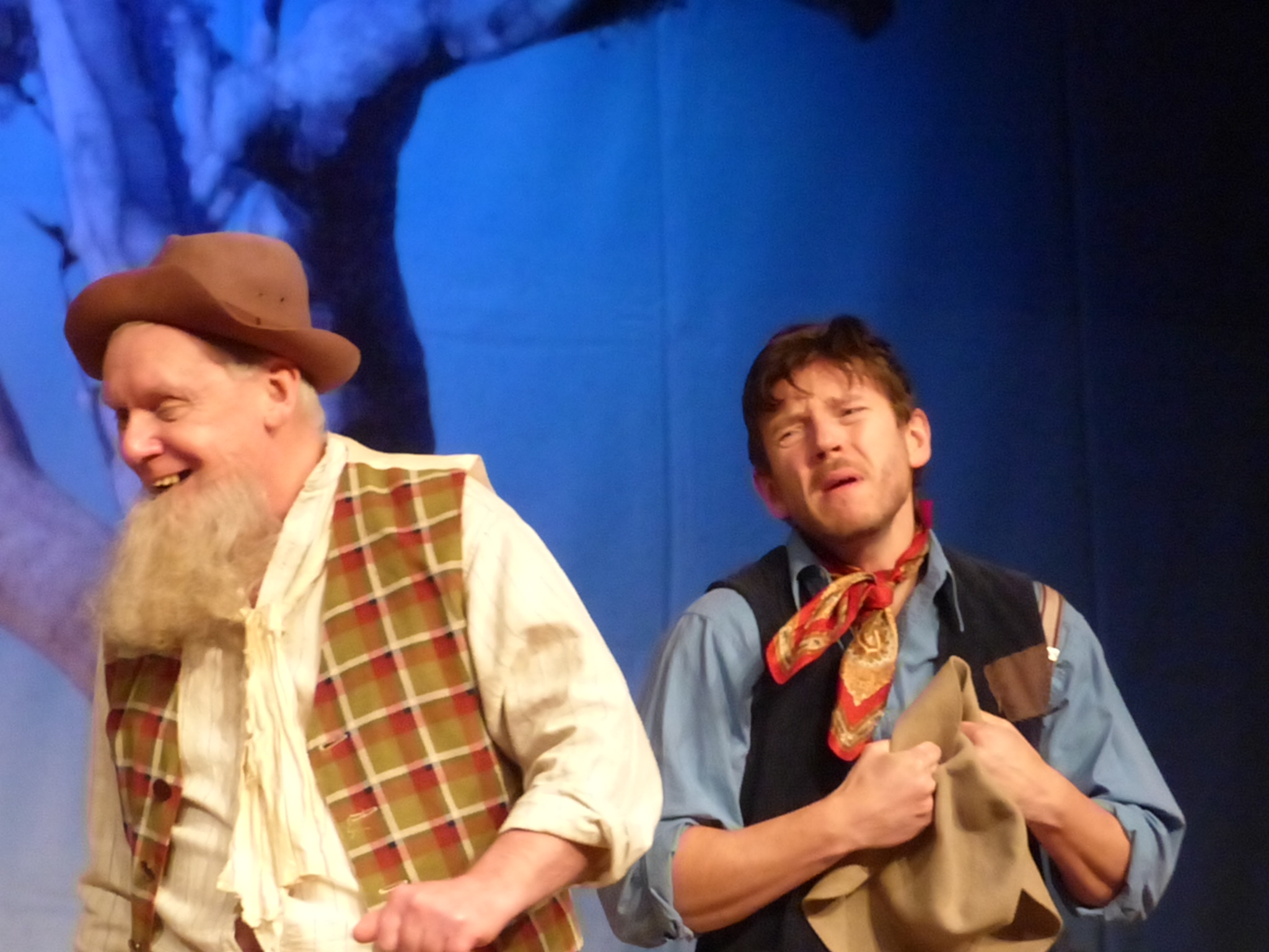 two men in costumes and hats are dancing