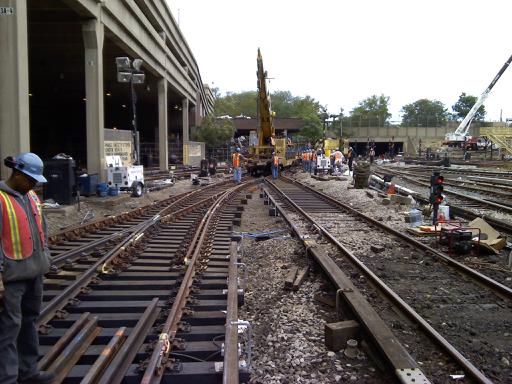 train tracks being constructed in front of a station