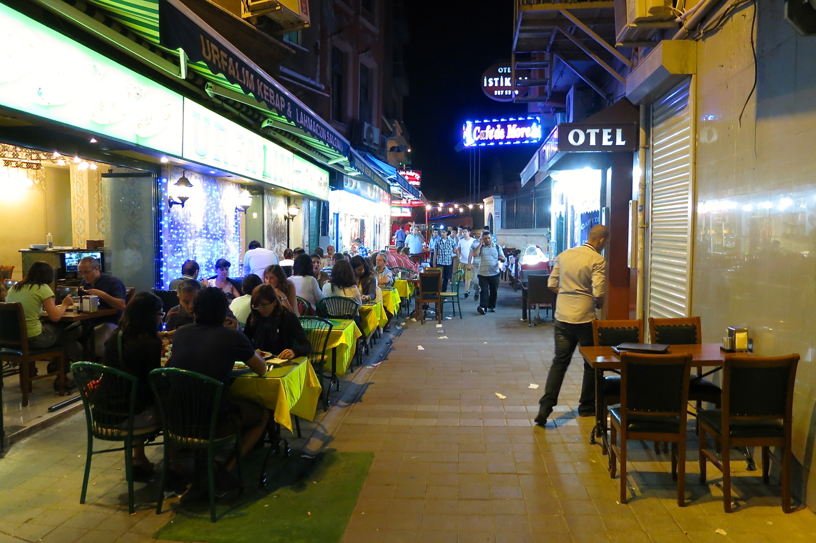 an image of people eating outside at night