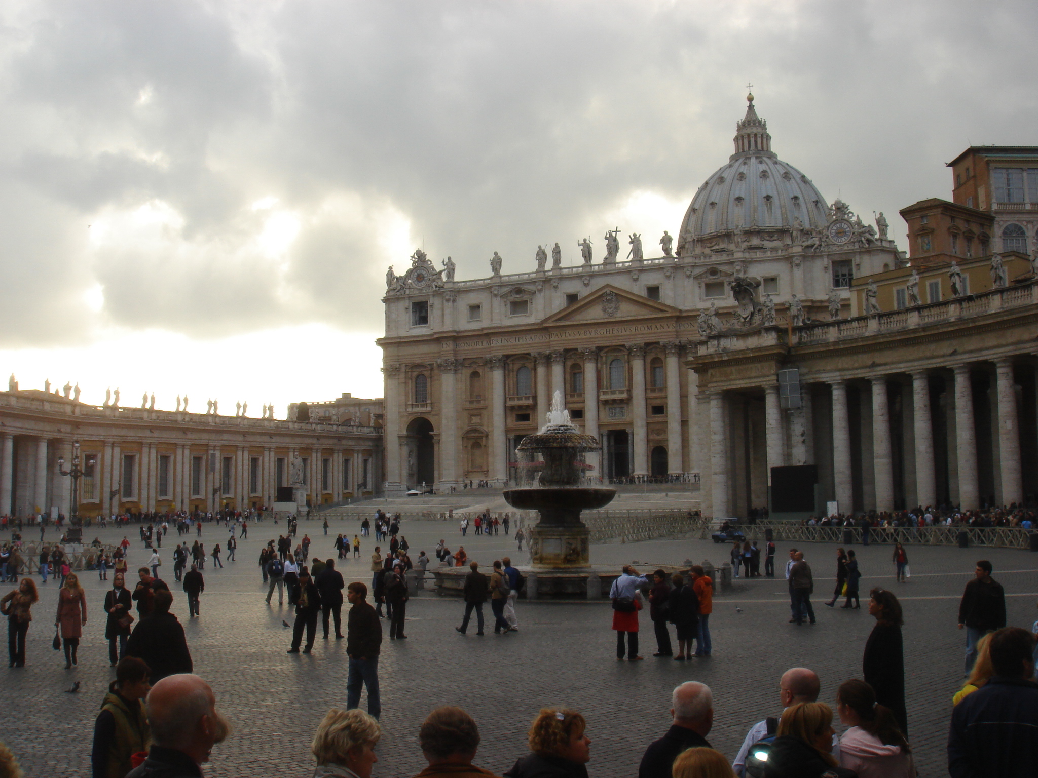 a crowd of people walking around a courtyard