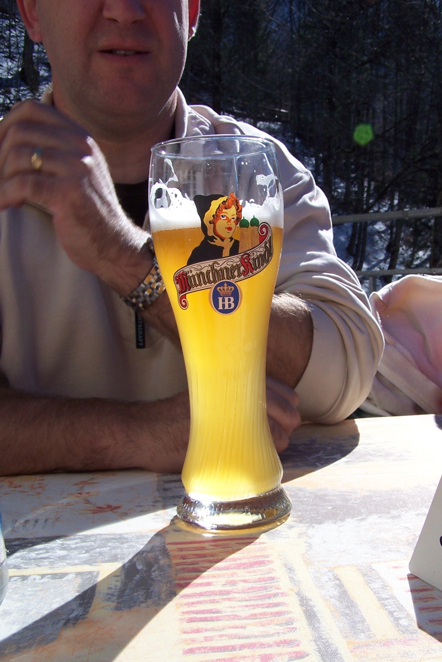 a man is having a pint of beer at a table