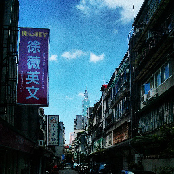 a busy asian street with many signs on the buildings