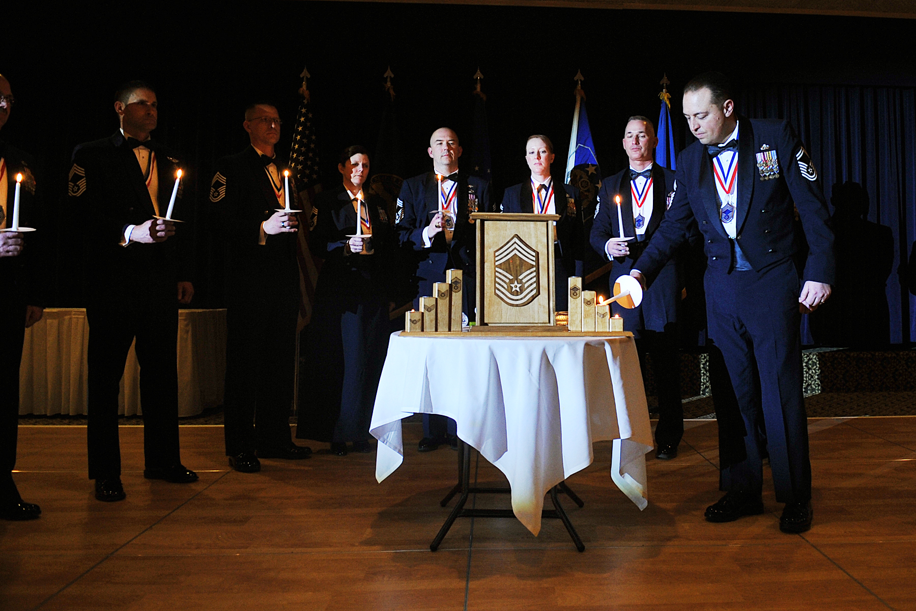 several men and one woman are holding their hands together