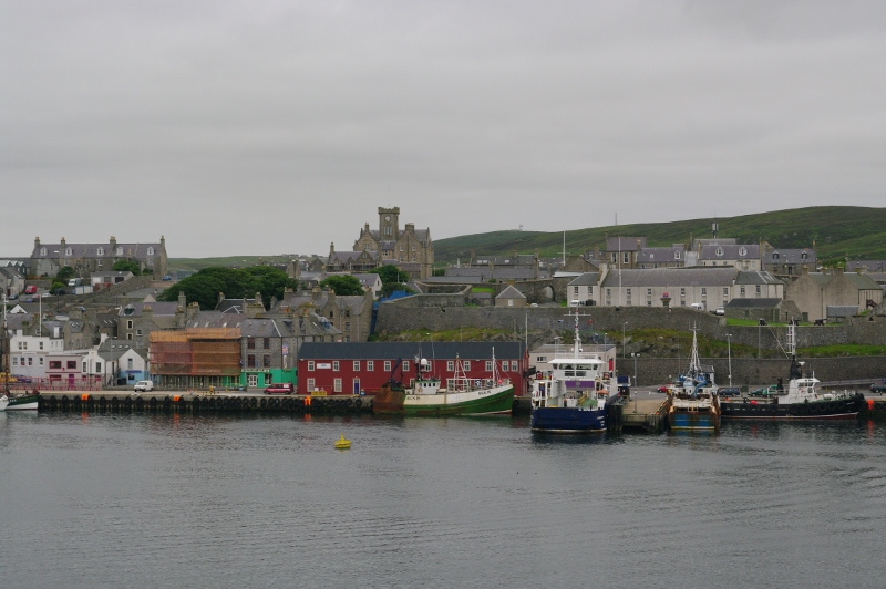 fishing boats are docked in the harbor of an island