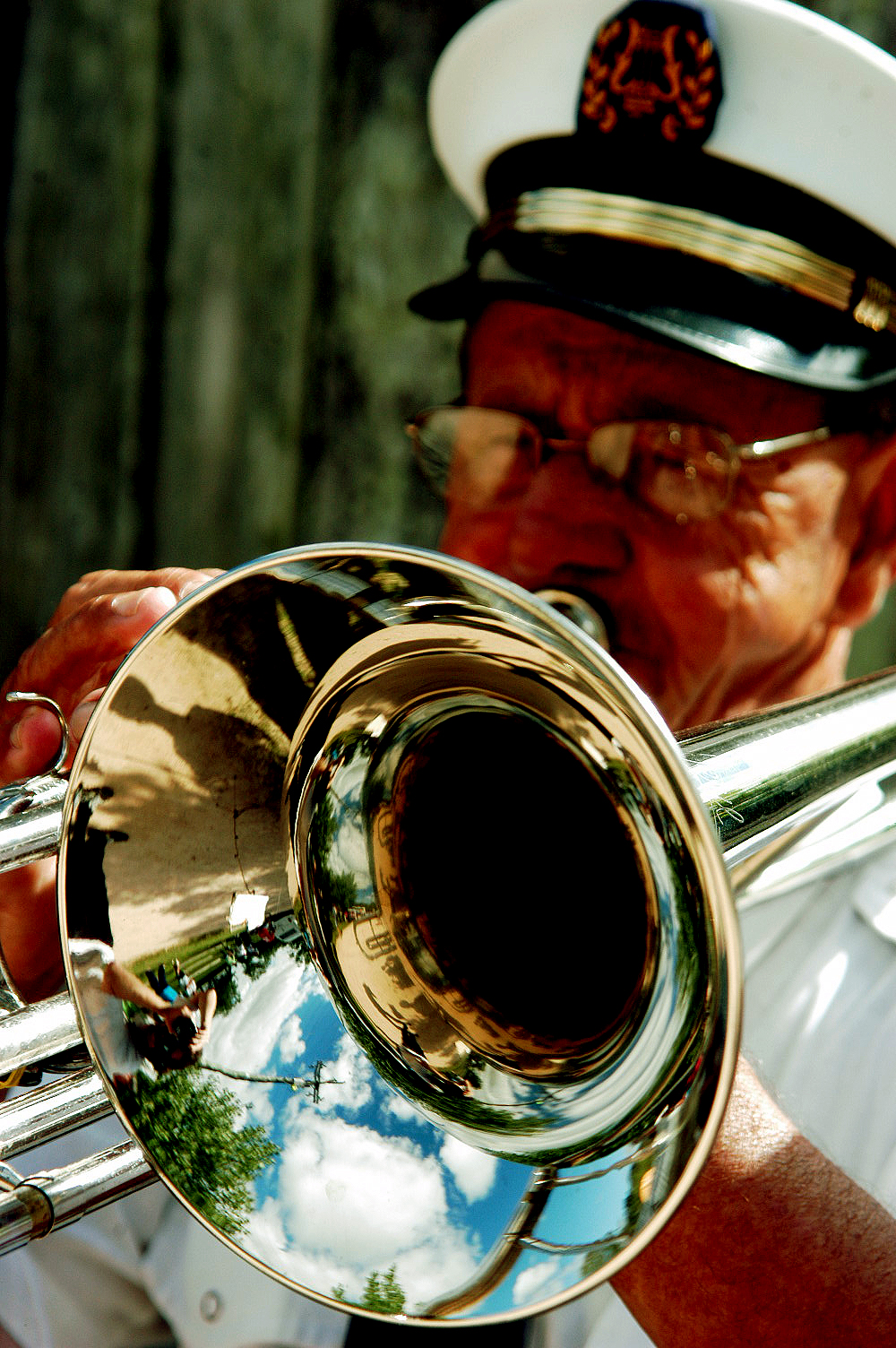 a naval man playing a trombone with another soldier