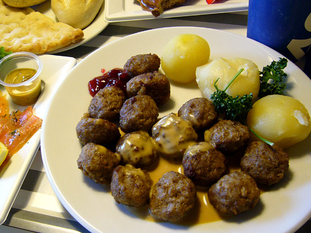 the plate is full of meatballs and potatoes