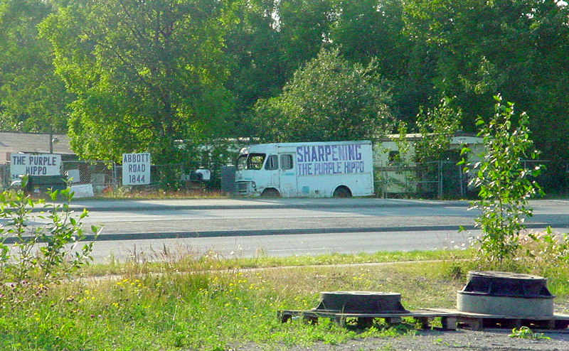 a large white truck is parked in front of an empty building