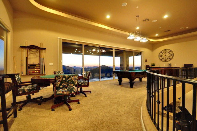 a living room with some couches and pool tables