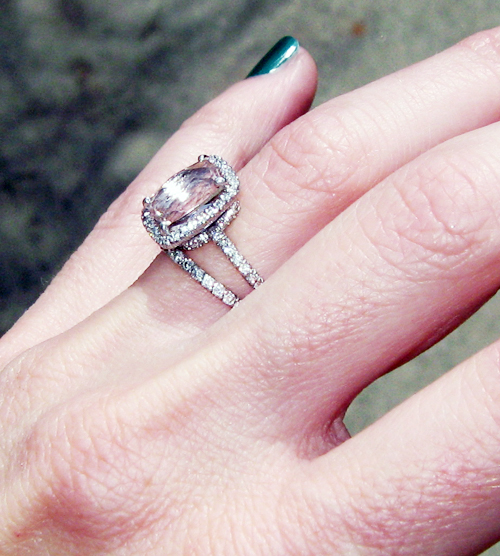 a person wearing a ring with a diamond on top