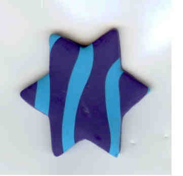 a glass blue and black star ornament on a wall