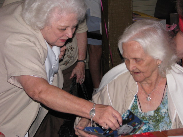an older woman hands soing to another older lady