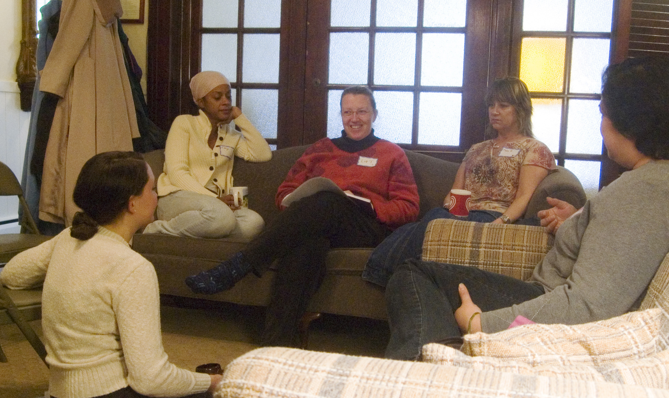several people gathered together in a living room