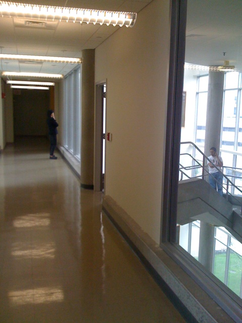 a hallway leading to two buildings in a hospital