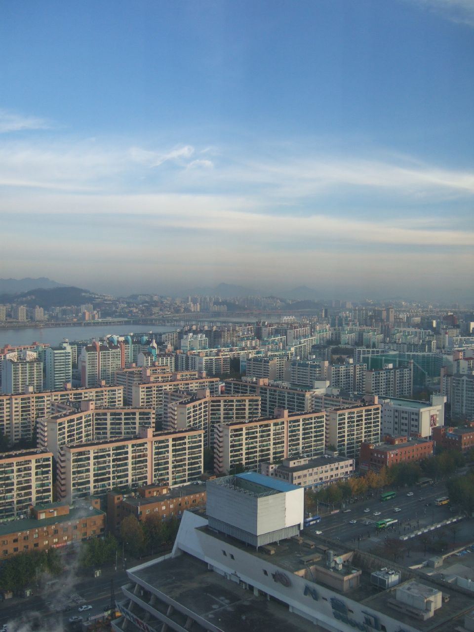 city buildings sitting next to a harbor with a large body of water in the background