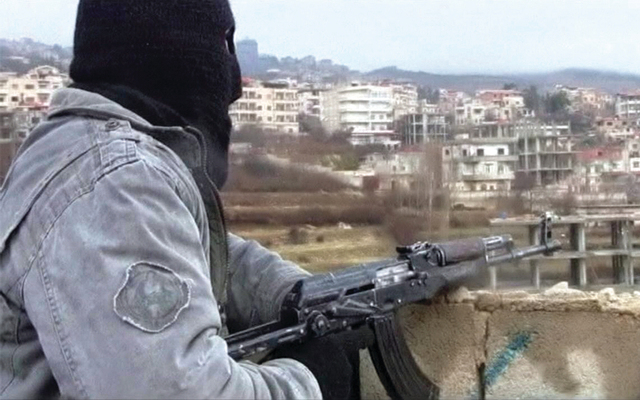 a person holding a gun in front of buildings