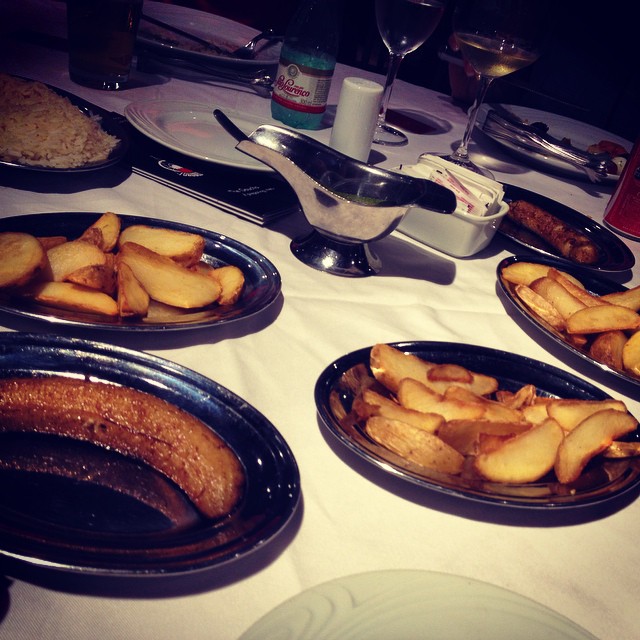 plates full of different types of foods sit on the table