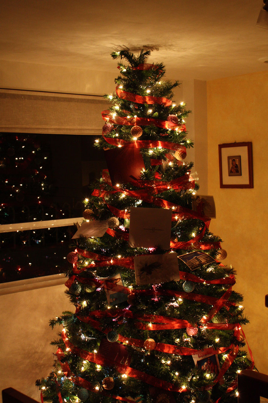 christmas tree decorated with lights and a lit display