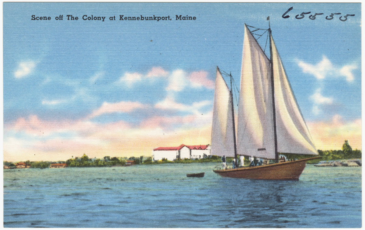 a sail boat on a blue body of water