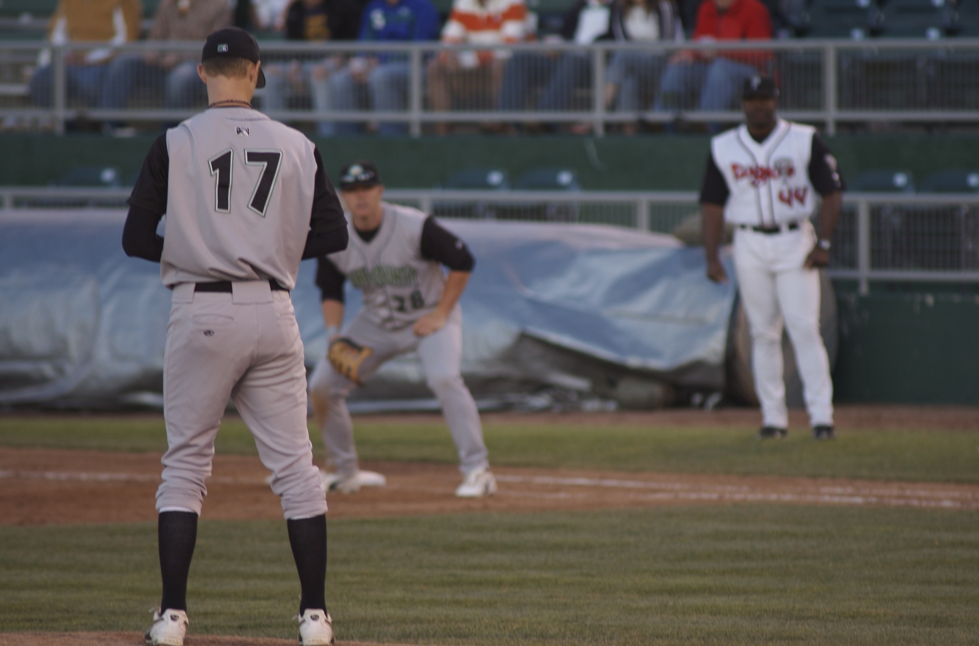 three baseball players standing on a baseball field