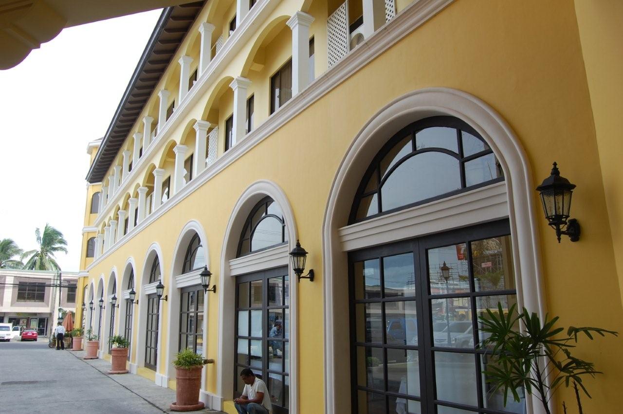 a yellow building with black trim and windows