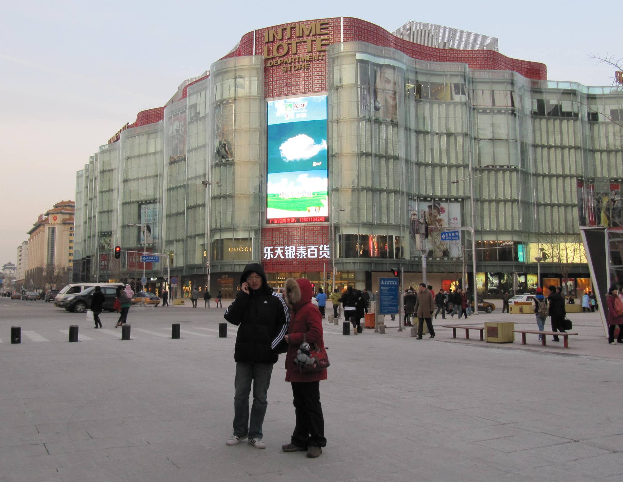 two people are talking in the middle of a square