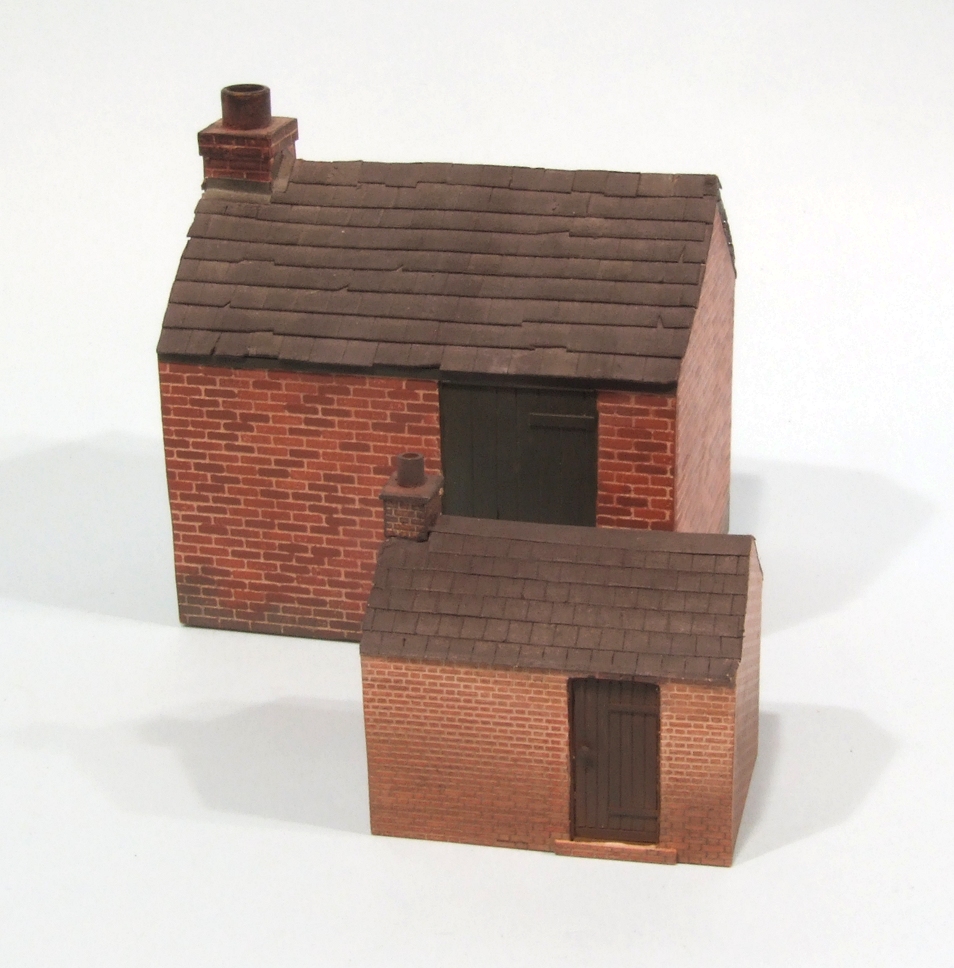 a brick and tile model house on white background