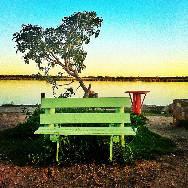 a bench sitting next to a body of water