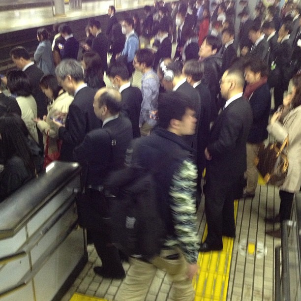 a large crowd of people on a subway platform