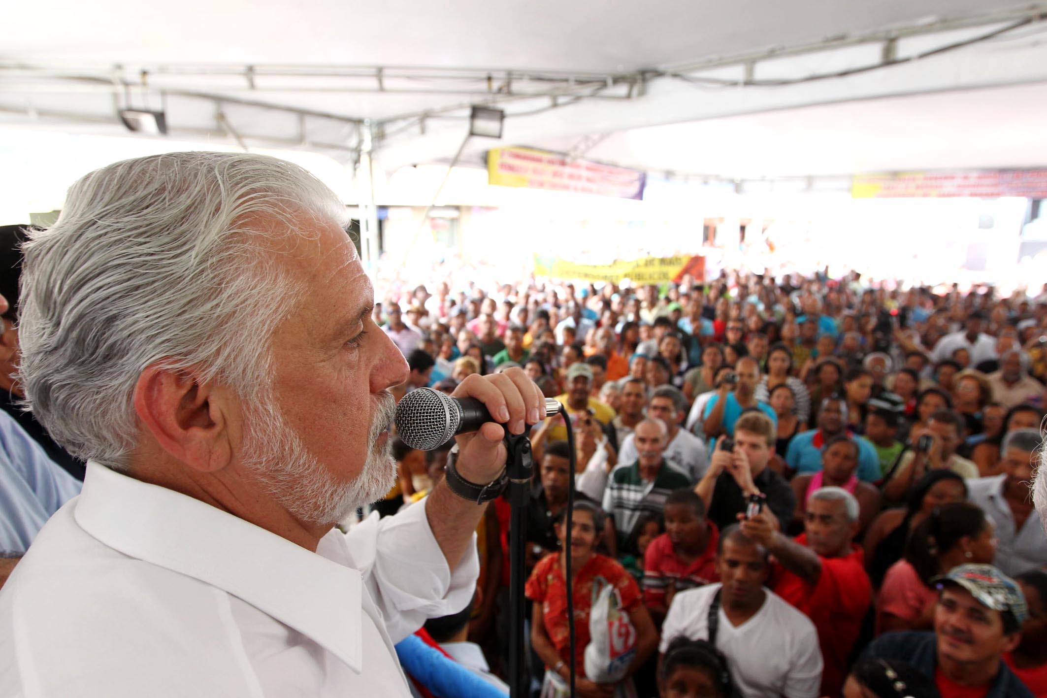 a man is shown speaking into a crowd