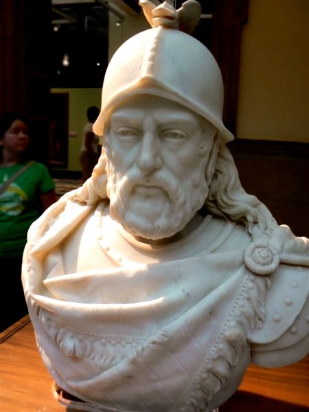a marble bust is displayed in a living room