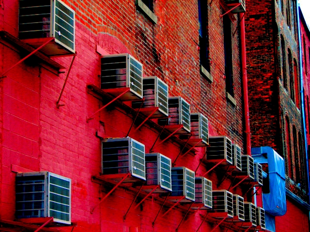 some red brick buildings are with white shutters