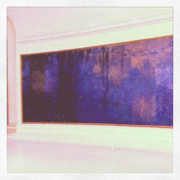 a painting of blue and purple on a white wall