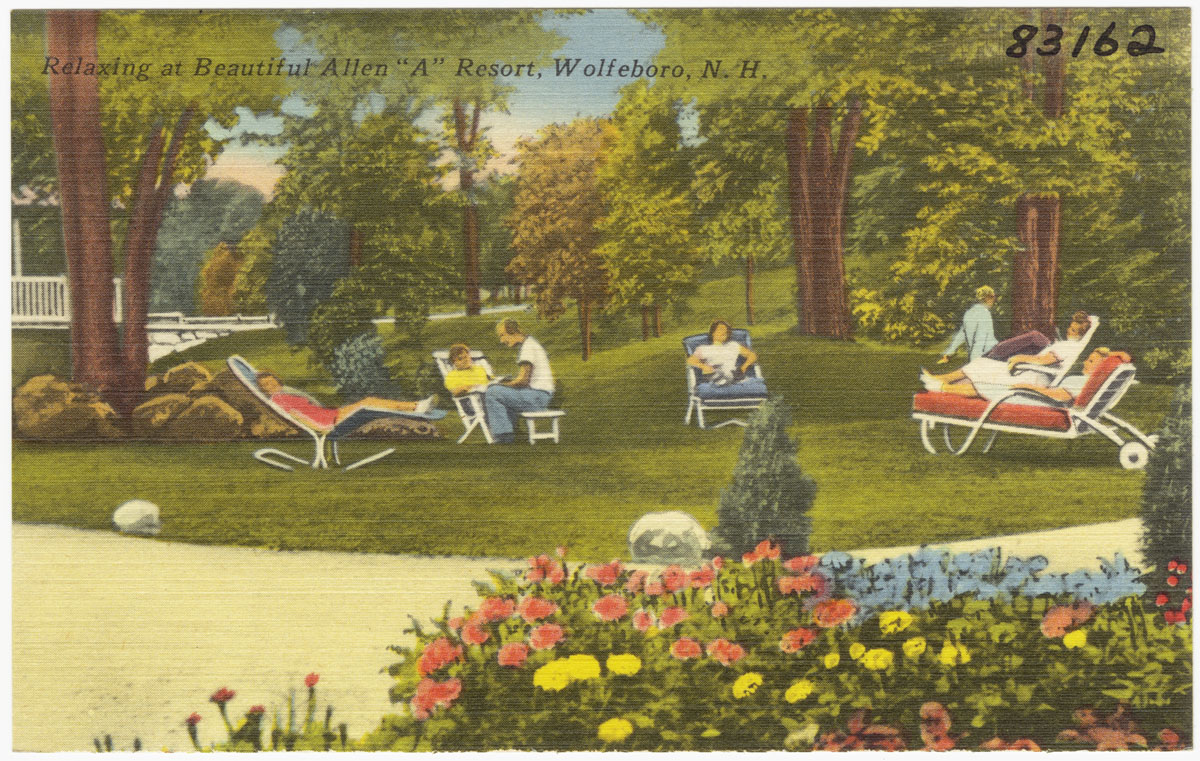 a group of people relax in lawn chairs next to a path