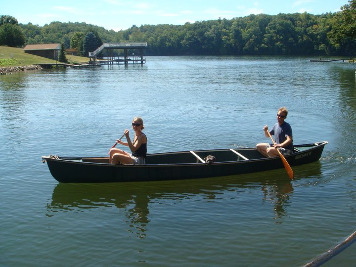 two people in a canoe rowing on water