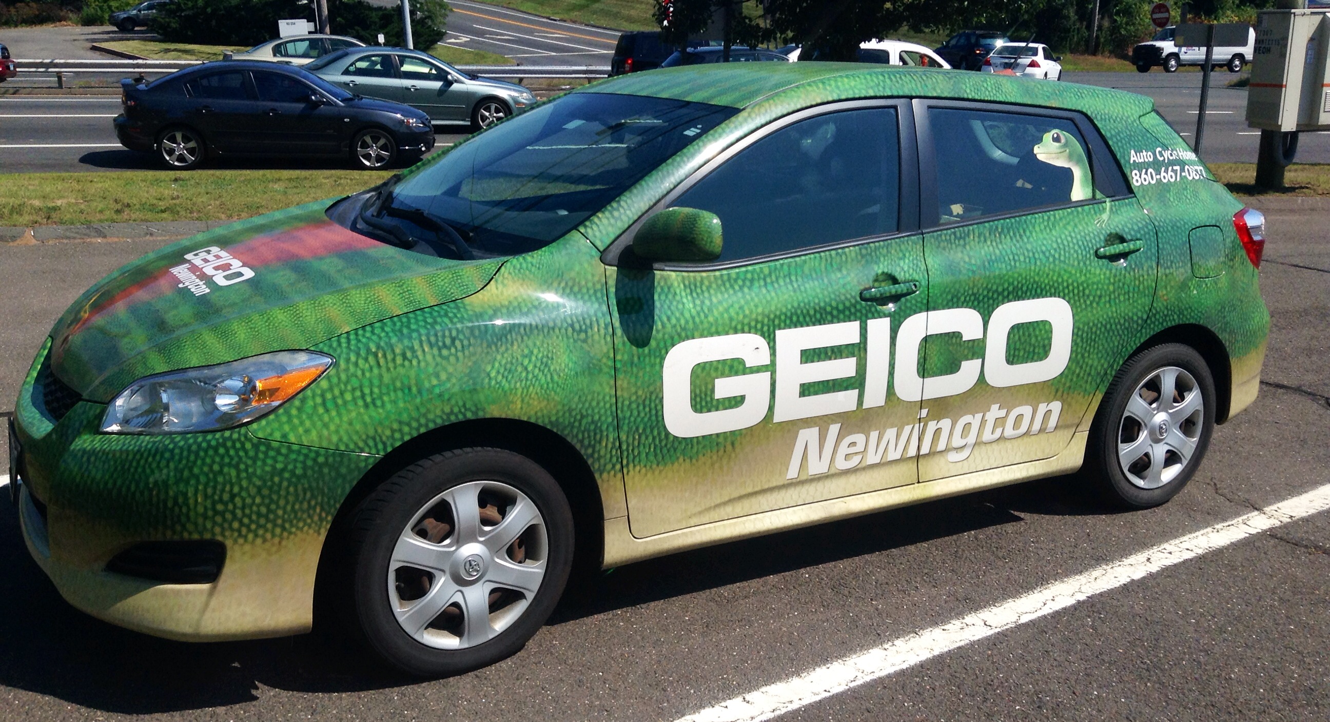 an automobile with a painted advertit sitting in the parking lot